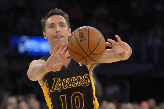 Los Angeles Lakers guard Steve Nash passes the ball during the first half of an NBA basketball game against the Washington Wizards, Friday, March 21, 2014, in Los Angeles. (AP Photo/Mark J. Terrill)