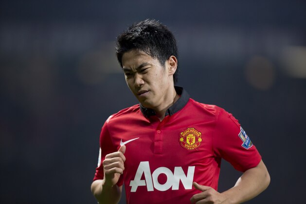 Manchester United's Shinji Kagawa winces as his team lose 3-0 to Manchester City during their English Premier League soccer match at Old Trafford Stadium, Manchester, England, Tuesday, March 25, 2014. (AP Photo/Jon Super)