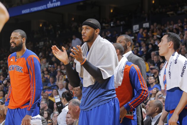 OAKLAND, CA - MARCH 30: Carmelo Anthony #7 of the New York Knicks cheers from the sideline in a game against the Golden State Warriors on March 30, 2014 at Oracle Arena in Oakland, California. NOTE TO USER: User expressly acknowledges and agrees that, by downloading and or using this photograph, user is consenting to the terms and conditions of Getty Images License Agreement. Mandatory Copyright Notice: Copyright 2014 NBAE (Photo by Rocky Widner/NBAE via Getty Images)