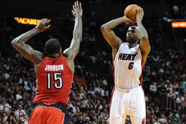 Jan 5, 2014; Miami, FL, USA; Miami Heat small forward LeBron James (6) shoots over Toronto Raptors power forward Amir Johnson (15) during the second half at American Airlines Arena. Miami won 102-97. Mandatory Credit: Steve Mitchell-USA TODAY Sports