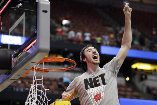Wisconsin 's Frank Kaminsky cuts down the net after a regional final NCAA college basketball tournament game against Arizona, Saturday, March 29, 2014, in Anaheim, Calif. Wisconsin won 64-63 in overtime. (AP Photo/Jae C. Hong)