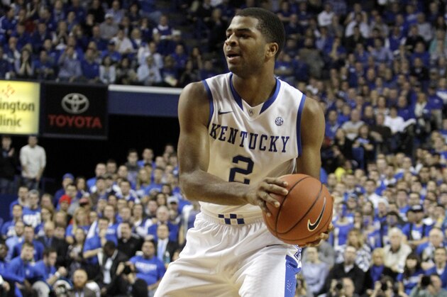 Kentucky's Aaron Harrison dribbles during the first half of an NCAA college basketball game against Louisville, Saturday, Dec. 28, 2013, in Lexington, Ky. (AP Photo/James Crisp)