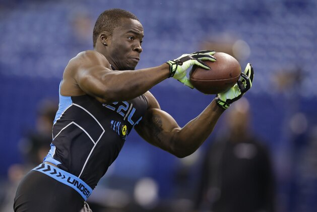 Boston Col linebacker Kevin Pierre-Louis runs a drill at the NFL football scouting combine in Indianapolis, Monday, Feb. 24, 2014. (AP Photo/Michael Conroy)
