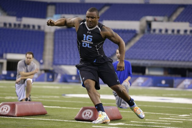Minnesota defensive lineman Ra'Shede Hageman runs a drill at the NFL football scouting combine in Indianapolis, Monday, Feb. 24, 2014. (AP Photo/Michael Conroy)