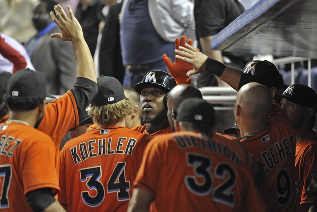 Mar 31, 2014; Miami, FL, USA; Miami Marlins right fielder Marcell Ozuna (center) is greeted by teammates after hitting a solo home run third inning of an opening day baseball game against the Colorado Rockies at Marlins Ballpark. Mandatory Credit: Steve Mitchell-USA TODAY Sports Mar 31, 2014; Miami, FL, USA; Miami Marlins right fielder Marcell Ozuna (center) is greeted by teammates after hitting a solo home run third inning of an opening day baseball game against the Colorado Rockies at Marlins Ballpark. Mandatory Credit: Steve Mitchell-USA TODAY Sports