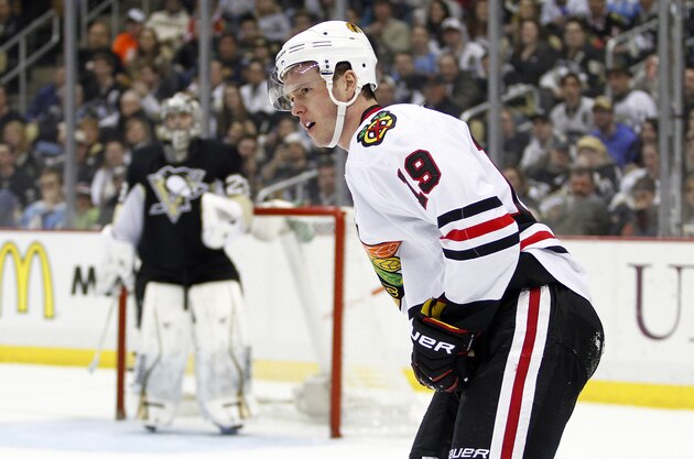 PITTSBURGH, PA - MARCH 30:  Jonathan Toews #19 of the Chicago Blackhawks skates off the ice after being checked into the corner by Brooks Orpik #44 of the Pittsburgh Penguins (not pictured) in the second period during the game at Consol Energy Center on March 30, 2014 in Pittsburgh, Pennsylvania.  (Photo by Justin K. Aller/Getty Images)