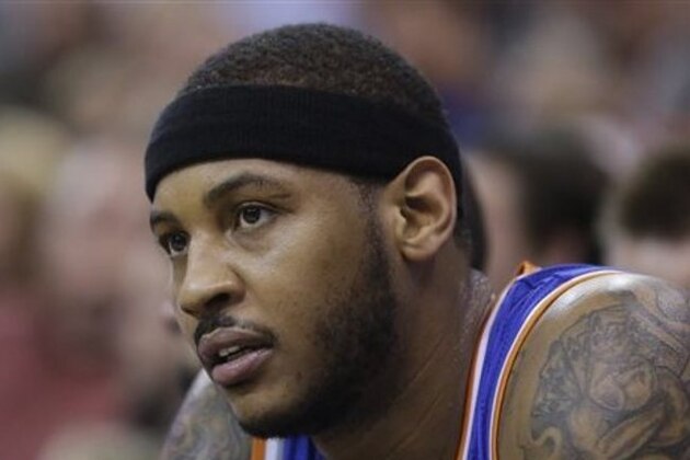 New York Knicks' Carmelo Anthony (7) looks on as he sits on the bench in the second quarter during an NBA basketball game against the Utah Jazz Monday, March 31, 2014, in Salt Lake City. (AP Photo/Rick Bowmer)