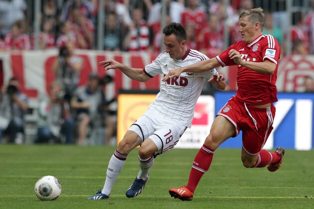 Nuremberg's Josip Drmic of Switzerland, left, and Bayern's Bastian Schweinsteiger challenge for the ball during the German first division Bundesliga soccer match between FC Bayern Munich and 1. FC Nuremberg, in Munich, southern Germany, Saturday, Aug. 24, 2013. (AP Photo/Matthias Schrader)