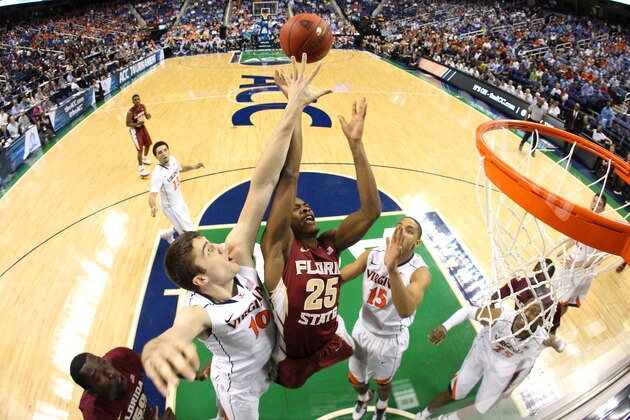 GREENSBORO, NC - MARCH 14:  Mike Tobey #10 of the Virginia Cavaliers and Aaron Thomas #25 of the Florida State Seminoles go after a rebound during the quarterfinals of the 2014 Men's ACC Basketball Tournament at Greensboro Coliseum on March 14, 2014 in Greensboro, North Carolina.  (Photo by Streeter Lecka/Getty Images)