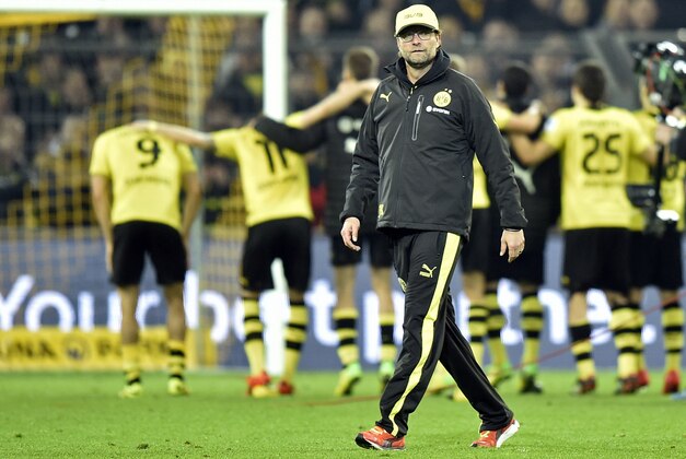 Dortmund head coach Juergen Klopp leaves the pitch after  the German Bundesliga soccer match between Borussia Dortmund and FC Schalke 04 in Dortmund,  Germany, Tuesday, March 25, 2014. (AP Photo/Martin Meissner)