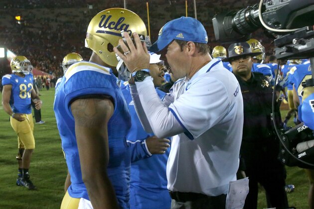 LOS ANGELES, CA - NOVEMBER 30:   Head coach Jim Mora of the UCLA Bruins embraces wide receiver Shaquelle Evans #1 after the game against the USC Trojans at Los Angeles Coliseum on November 30, 2013 in Los Angeles, California.  The Bruins won 35-14.  (Photo by Stephen Dunn/Getty Images)