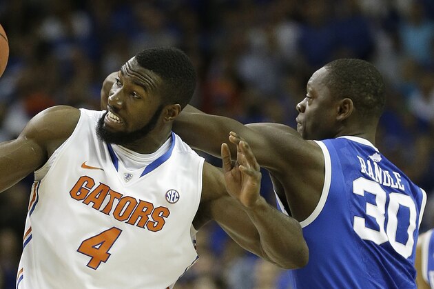 Florida center Patric Young (4) and Kentucky forward Julius Randle (30) vie for a loose ball during the first half of an NCAA college basketball game in the Championship round of the Southeastern Conference men's tournament, Sunday, March 16, 2014, in Atlanta. (AP Photo/Steve Helber)