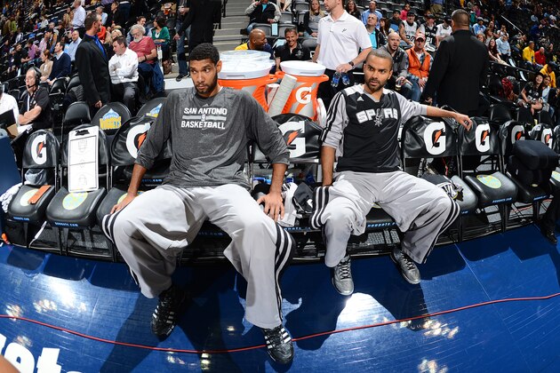 DENVER, CO - NOVEMBER 5: Tony Parker #9 (R) and  Tim Duncan #21 (L) of the San Antonio Spurs look on against the Denver Nuggets on November 5, 2013 at the Pepsi Center in Denver, Colorado. NOTE TO USER: User expressly acknowledges and agrees that, by downloading and/or using this Photograph, user is consenting to the terms and conditions of the Getty Images License Agreement. Mandatory Copyright Notice: Copyright 2013 NBAE (Photo by Garrett W. Ellwood/NBAE via Getty Images)