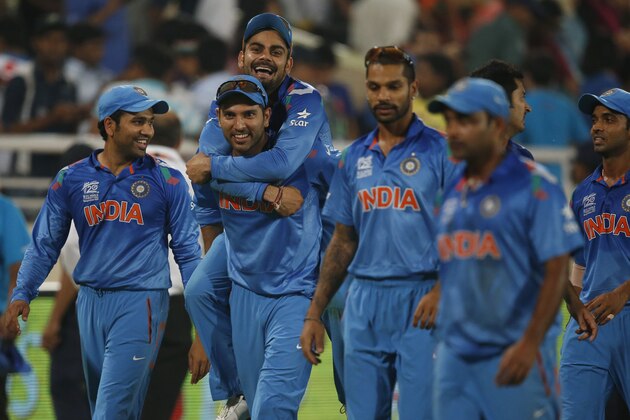 India's Yuvraj Singh, second left, carries teammate Virat Kohli on his back as they celebrate their win over Australia in their ICC Twenty20 Cricket World Cup match in Dhaka, Bangladesh, Sunday, March 30, 2014. India won the match by 73 runs. (AP Photo/Aijaz Rahi)