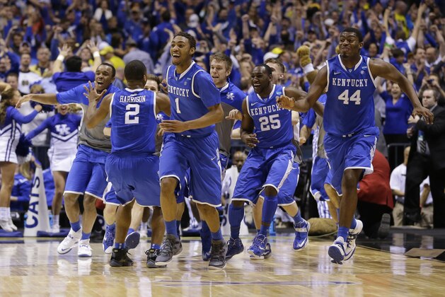 Kentucky  players celebrate after an NCAA Midwest Regional final college basketball tournament game against Michigan Sunday, March 30, 2014, in Indianapolis. Kentucky won 75-72 to advance to the Final Four.(AP Photo/Michael Conroy)