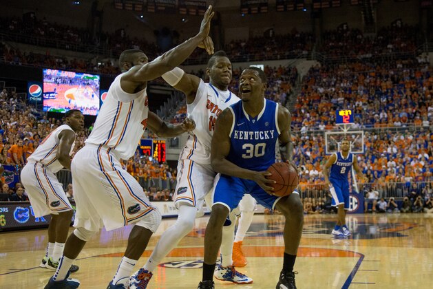 GAINESVILLE, FL - MARCH 08: Julius Randle #30 of the Kentucky Wildcats is defended by Will Yeguete #15 and Patric Young #4 of the Florida Gators during the second half of the game at the Stephen C. O'Connell Center on March 8, 2014 in Gainesville, Florida. (Photo by Rob Foldy/Getty Images)