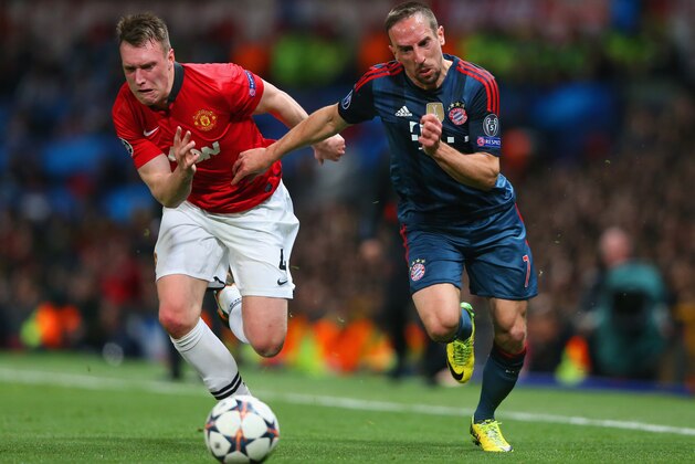 MANCHESTER, ENGLAND - APRIL 01: Phil Jones of Manchester United and Franck Ribery of Bayern Muenchen compete for the ball during the UEFA Champions League Quarter Final first leg match between Manchester United and FC Bayern Muenchen at Old Trafford on April 1, 2014 in Manchester, England.  (Photo by Alex Livesey/Getty Images)