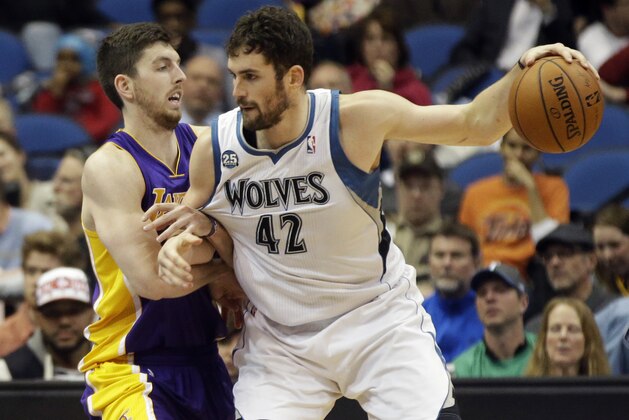 Los Angeles Lakers' Ryan Kelly, left, tries to slow down Minnesota Timberwolves' Kevin Love in the second half of an NBA basketball game against the Minnesota Timberwolves, Tuesday, Feb. 4, 2014, in Minneapolis. The Timberwolves won 109-99. The game marked the first for Nash since early November as he recovered from a back injury. (AP Photo/Jim Mone)
