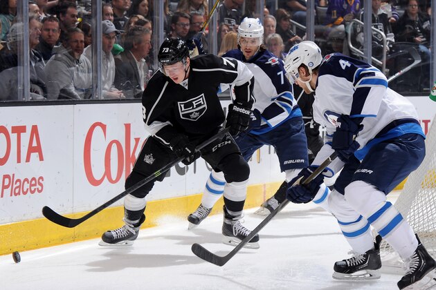 LOS ANGELES, CA - MARCH 29:  Tyler Toffoli #73 of the Los Angeles Kings skates with the puck against Keaton Ellerby #7 and Paul Postma #4 of the Winnipeg Jets at Staples Center on March 29, 2014 in Los Angeles, California. (Photo by Noah Graham/NHLI via Getty Images)