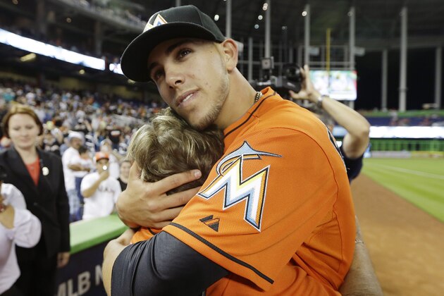Miami Marlins starting pitcher Jose Fernandez, right, hugs his grandmother Olga Fernandez, of Cuba, left, following the Marlins' 10-1 victory over the Colorado Rockies during an opening day baseball game, Monday, March 31, 2014, in Miami. (AP Photo/Lynne Sladky)