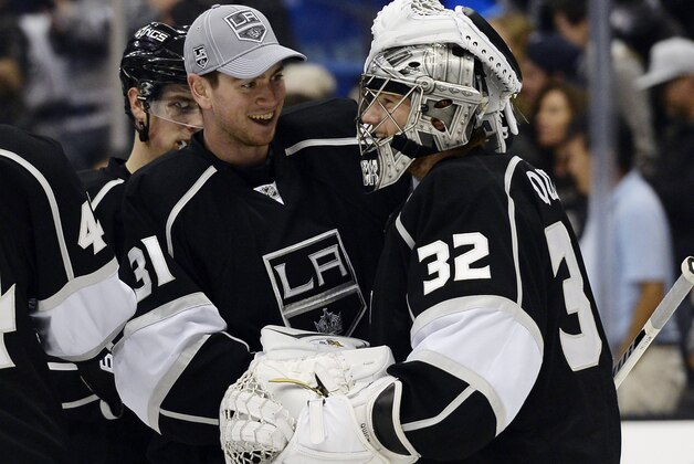 Los Angeles Kings goalie Jonathan Quick (32) celebrates with Los Angeles Kings back up goalie Martin Jones (31) after defeating the Winnipeg jets, 4-2, after thier NHL hockey game at the Staples Center Saturday, March 29, 2014, in Los Angeles. (AP Photo/Kevork Djansezian)