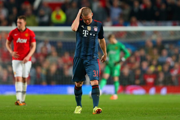 MANCHESTER, ENGLAND - APRIL 01:  A dejected Bastian Schweinsteiger of Bayern Muenchen holds his head after he was shown a red card during the UEFA Champions League Quarter Final first leg match between Manchester United and FC Bayern Muenchen at Old Trafford on April 1, 2014 in Manchester, England.  (Photo by Alex Livesey/Getty Images)