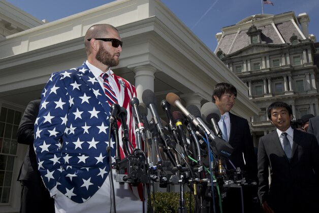 Boston Red Sox outfielder Jonny Gomes, left, speaks to reporters in front of the West Wing of the White House in Washington, Tuesday, April 1, 2014, following a ceremony where President Barack Obama honored the 2013 World Series baseball champion the Boston Red Sox on the White House South Lawn.  (AP Photo/Manuel Balce Ceneta)