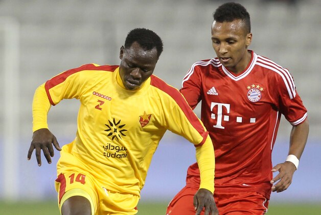 FILE - In this Jan. 9, 2014, file photo, Bayern Munich's Julian Green, right, of Munich, and Balla Jabir, of Al-Merrikh, challenge for the ball, during their friendly soccer match, at Al-Saad stadium in Doha. Green has joined the U.S. soccer team, a glistening talent still developing, a youngster who grew up in Germany with regular trips to see his father in Florida. He will make his debut for the United States against Mexico on Wednesday, April 2. (AP Photo/Osama Faisal, File)