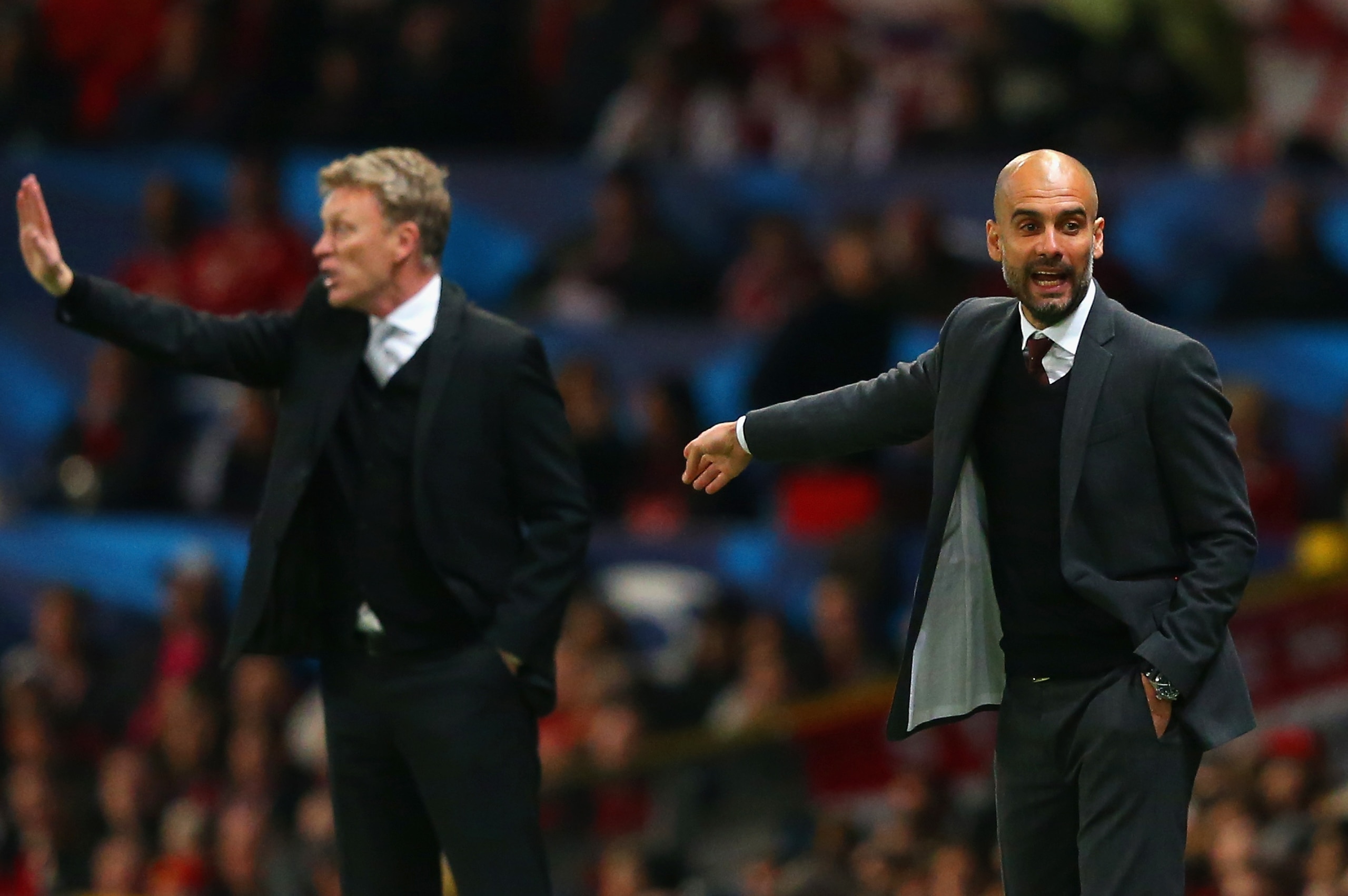 MANCHESTER, ENGLAND - APRIL 01:  David Moyes manager of Manchester United and Pep Guardiola head coach of Bayern Muenchen give instructions during the UEFA Champions League Quarter Final first leg match between Manchester United and FC Bayern Muenchen at Old Trafford on April 1, 2014 in Manchester, England.  (Photo by Alex Livesey/Getty Images)
