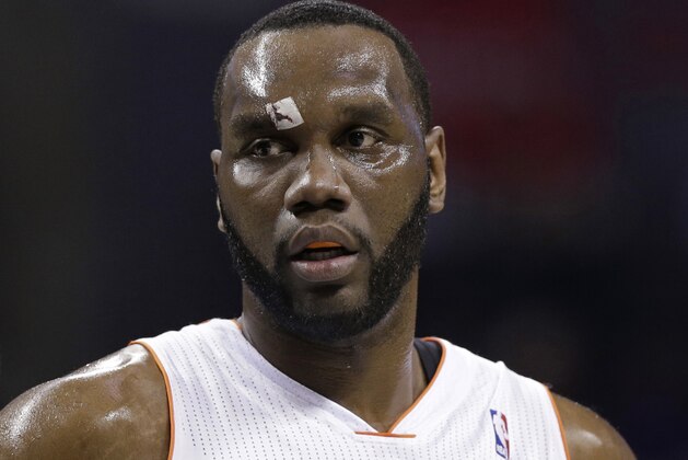 Charlotte Bobcats' Al Jefferson walks to the free throw line with a bandage over his right eye after being injured during the first half of an NBA basketball game against the Washington Wizards in Charlotte, N.C., Monday, March 31, 2014. (AP Photo/Chuck Burton)