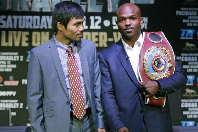 Boxer Manny Pacquiao, of the Phillipines, left, glances at his opponent Timothy Bradley of Indio, Ca., while posing for a photo with the current WBO World Welterweight champion during a press conference,Thursday, Feb. 6, 2014, in New York.  The pair will face off in a title fight April 12, 2014, in Las Vegas. (AP Photo/Kathy Willens)