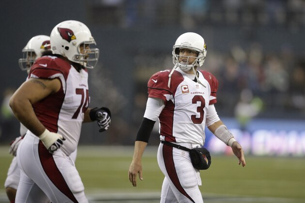 Arizona Cardinals quarterback Carson Palmer walks off the field in the second half of an NFL football game against the Seattle Seahawks, Sunday, Dec. 22, 2013, in Seattle. (AP Photo/Stephen Brashear)