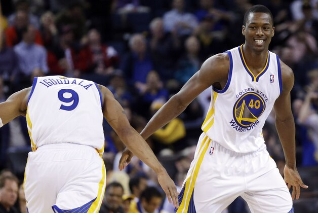 Golden State Warriors' Harrison Barnes celebrates with teammate Andre Iguodala during the second half of an NBA basketball game on Thursday, Feb. 6, 2014, in Oakland, Calif. Golden State won 102-87. (AP Photo/Marcio Jose Sanchez)