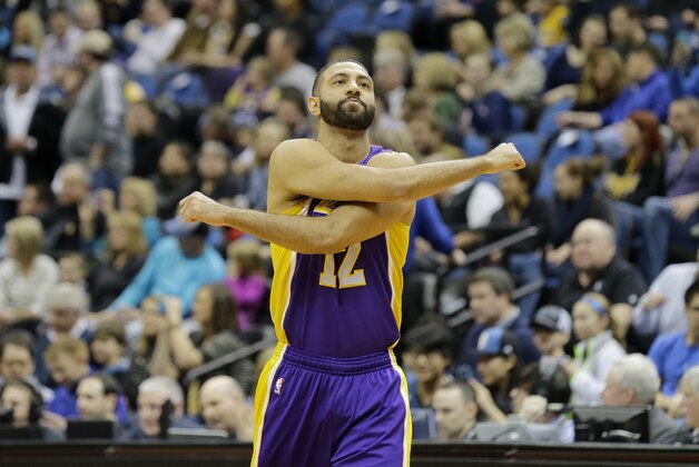 Los Angeles Lakers guard Kendall Marshall (12) stretches during the first quarter of an NBA basketball game against the Minnesota Timberwolves in Minneapolis, Friday, March 28, 2014.  (AP Photo/Ann Heisenfelt)