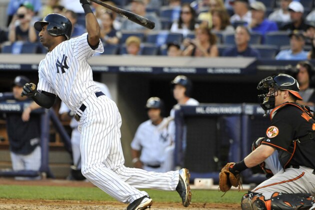New York Yankees'  Eduardo Nunez hits an RBI single in front of Baltimore Orioles catcher Matt Wieters in the first inning of the second baseball game of a doubleheader on Saturday, July 30, 2011 at Yankee Stadium in New York. (AP Photo/Kathy Kmonicek)