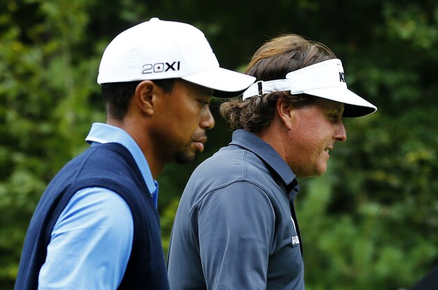 NORTON, MA - AUGUST 30:  Tiger Woods (L) and Phil Mickelson of the USA walk on the 12th hole during the first round of the Deutsche Bank Championship at TPC Boston on August 30, 2013 in Norton, Massachusetts.  (Photo by Jim Rogash/Getty Images)