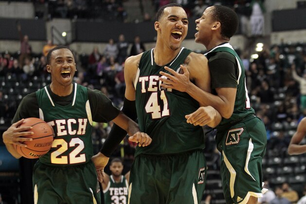 Arsenal Technical High School's Trey Lyles, center, Jeremie Tyler, left, and CJ Walker celebrate after defeating Lake Central High School 63-59 in the IHSAA Class 4A Indiana state boys' basketball championship game in Indianapolis, Saturday, March 29, 2014. (AP Photo/AJ Mast)