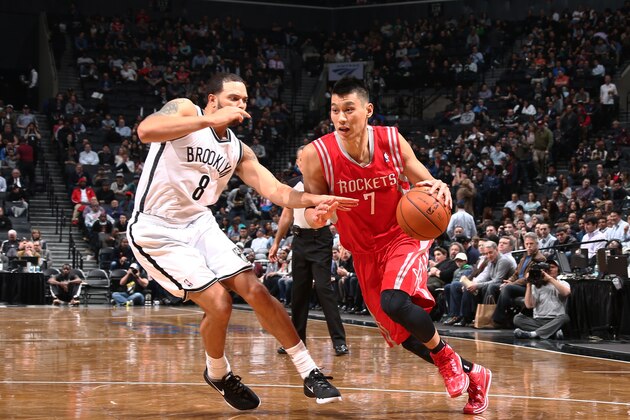 Houston Rockets guard Jeremy Lin (7) shoots against Brooklyn Nets guard Shaun Livingston (14) as forward Paul Pierce (34) looks on during the second half of their NBA basketball game at the Barclays Center, Tuesday, April 1, 2014, in New York. (AP Photo/John Minchillo)
