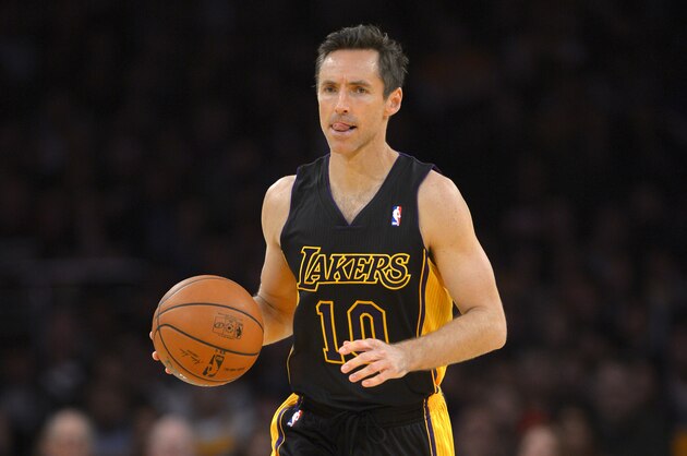 Los Angeles Lakers guard Steve Nash dribbles the ball during the first half of an NBA basketball game against the Washington Wizards, Friday, March 21, 2014, in Los Angeles. (AP Photo/Mark J. Terrill)
