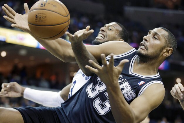 San Antonio Spurs' Boris Diaw (33), of France, gets a defensive rebound from Memphis Grizzlies' James Johnson in the first half of an NBA basketball game in Memphis, Tenn., Tuesday, Jan. 7, 2014. (AP Photo/Danny Johnston)