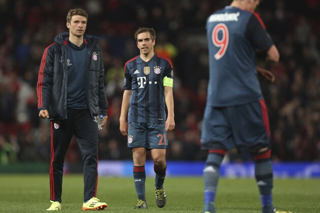 Bayern's Thomas Mueller, Philipp Lahm and  Mario Mandzukic, from left, leave the pitch after the Champions League quarterfinal first leg soccer match between Manchester United and Bayern Munich at Old Trafford Stadium, Manchester, England, Tuesday, April 1, 2014.(AP Photo/Jon Super)