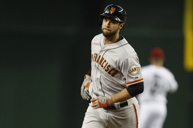 San Francisco Giants first baseman Brandon Belt (9) runs the bases after hitting a three run homerun against the Arizona Diamondbacks in the first inning during a baseball game against the Arizona Diamondbacks, Tuesday, April 1, 2014, in Phoenix. (AP Photo/Rick Scuteri)