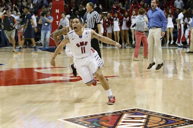 SMU guard Nic Moore (11) celebrates as time expires in an NCAA college basketball game against California in the quarterfinals of the NIT, Wednesday, March 26, 2014, in Dallas. SMU won 67-65 and Moorw hit the game-winning basket. (AP Photo/Sharon Ellman)