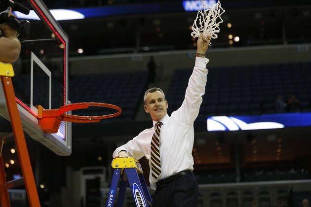 Florida head coach Billy Donovan, holds part of the net after the second half in a regional final game against Dayton at the NCAA college basketball tournament, Saturday, March 29, 2014, in Memphis, Tenn. Florida won 62-52. (AP Photo/John Bazemore)