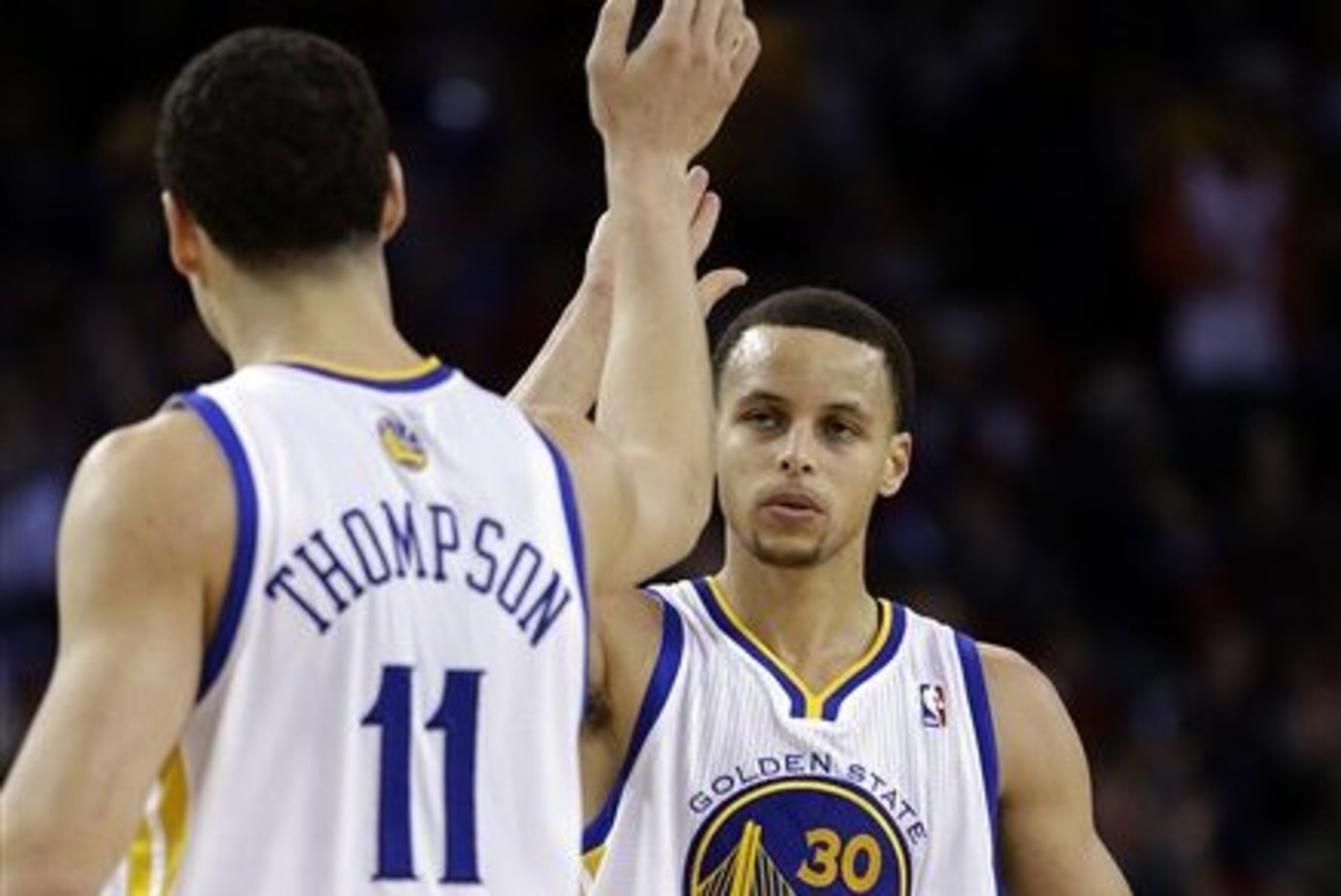 Golden State Warriors' Stephen Curry, right, is congratulated by Klay Thompson after Curry scored against the New York Knicks during the second half of an NBA basketball game Monday, March 11, 2013, in Oakland, Calif. (AP Photo/Ben Margot)