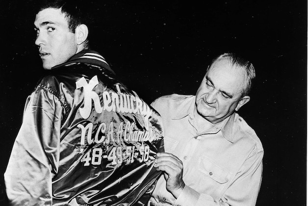 University of Kentucky coach Adolph Rupp looks at the back of Johnny Cox's jacket, Dec. 1, 1958.  Kentucky has won four NCAA championships, in 1948, '49, '51, and '58.  (AP Photo)