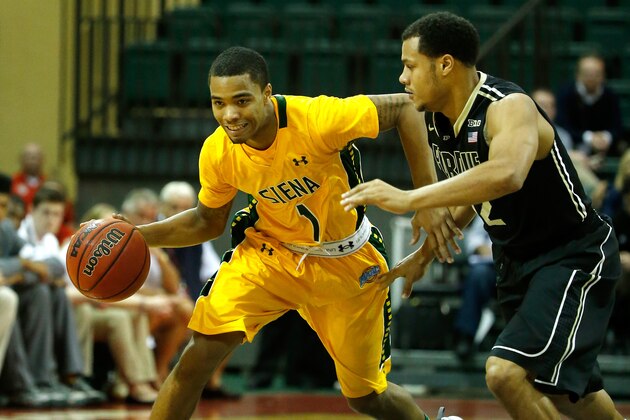 ORLANDO, FL - DECEMBER 01:  Bryson Scott #12 of the Purdue Boilermakers gaurds Marquis Wright #1 of the Siena Saints during the Old Spice Classic at HP Field House on December 1, 2013 in Orlando, Florida.  (Photo by Sam Greenwood/Getty Images)