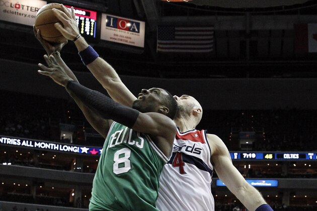 Boston Celtics forward Jeff Green (8) has his shot blocked by Washington Wizards center Marcin Gortat (4), from Poland, in the first half of an NBA basketball game, Wednesday, Jan. 22, 2014, in Washington. (AP Photo/Alex Brandon)