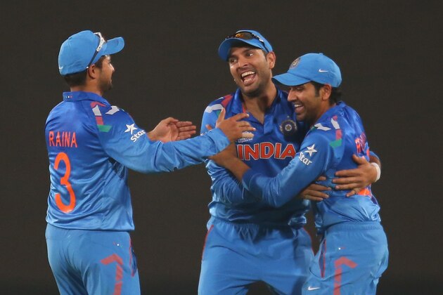 DHAKA, BANGLADESH - MARCH 30:  Rohit Sharma of India celebrates with Yuvraj Singh after taking a catch to dismiss David Warner of Australia during the ICC World Twenty20 Bangladesh 2014 match between India v Australia at Sher-e-Bangla Mirpur Stadium on March 30, 2014 in Dhaka, Bangladesh.  (Photo by Scott Barbour/Getty Images)