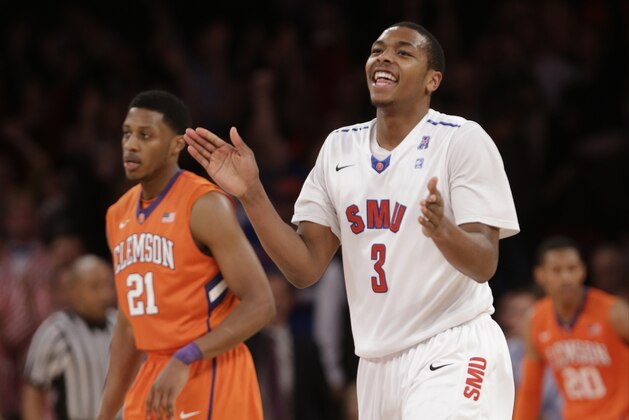 SMU's Sterling Brown (3) and Clemson's Damarcus Harrison (21)react during the second half of an NCAA college basketball game in the semifinals of the NIT Tuesday, April 1, 2014, in New York. SMU won the game 65-59. (AP Photo/Frank Franklin II)